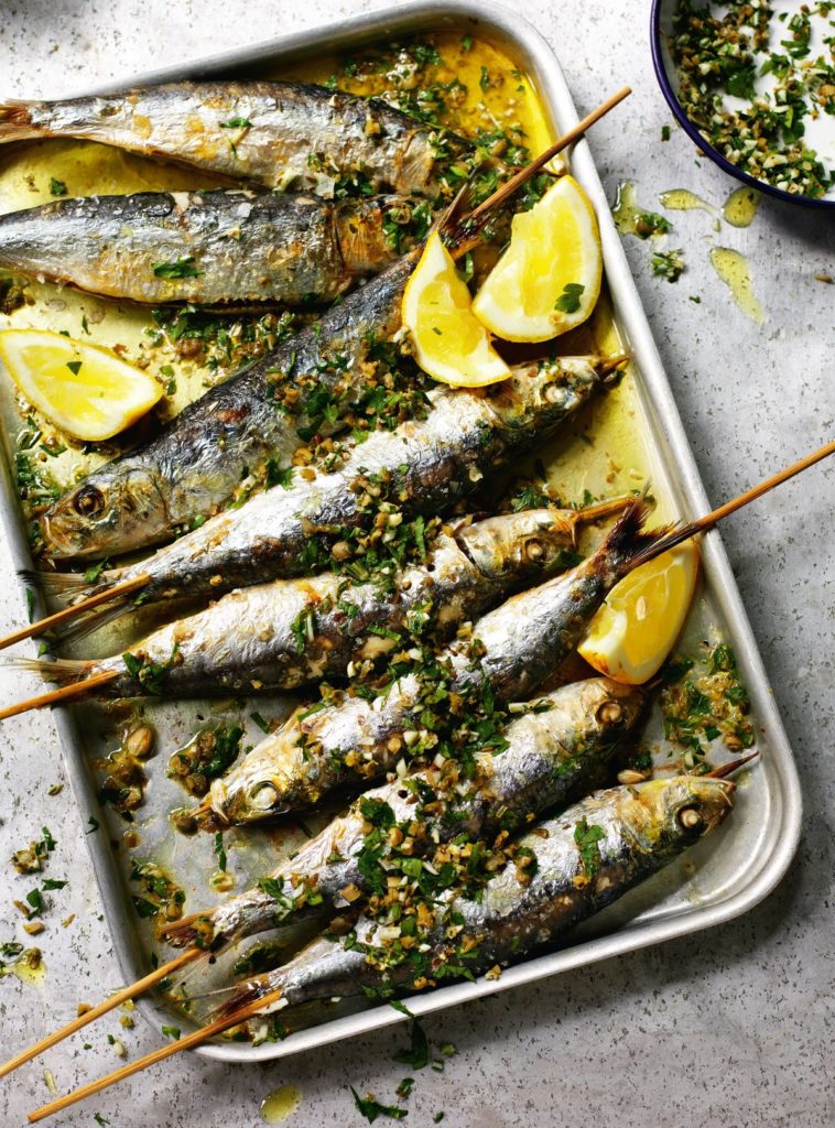 Grilled sardines with coarsely chopped green herbs
