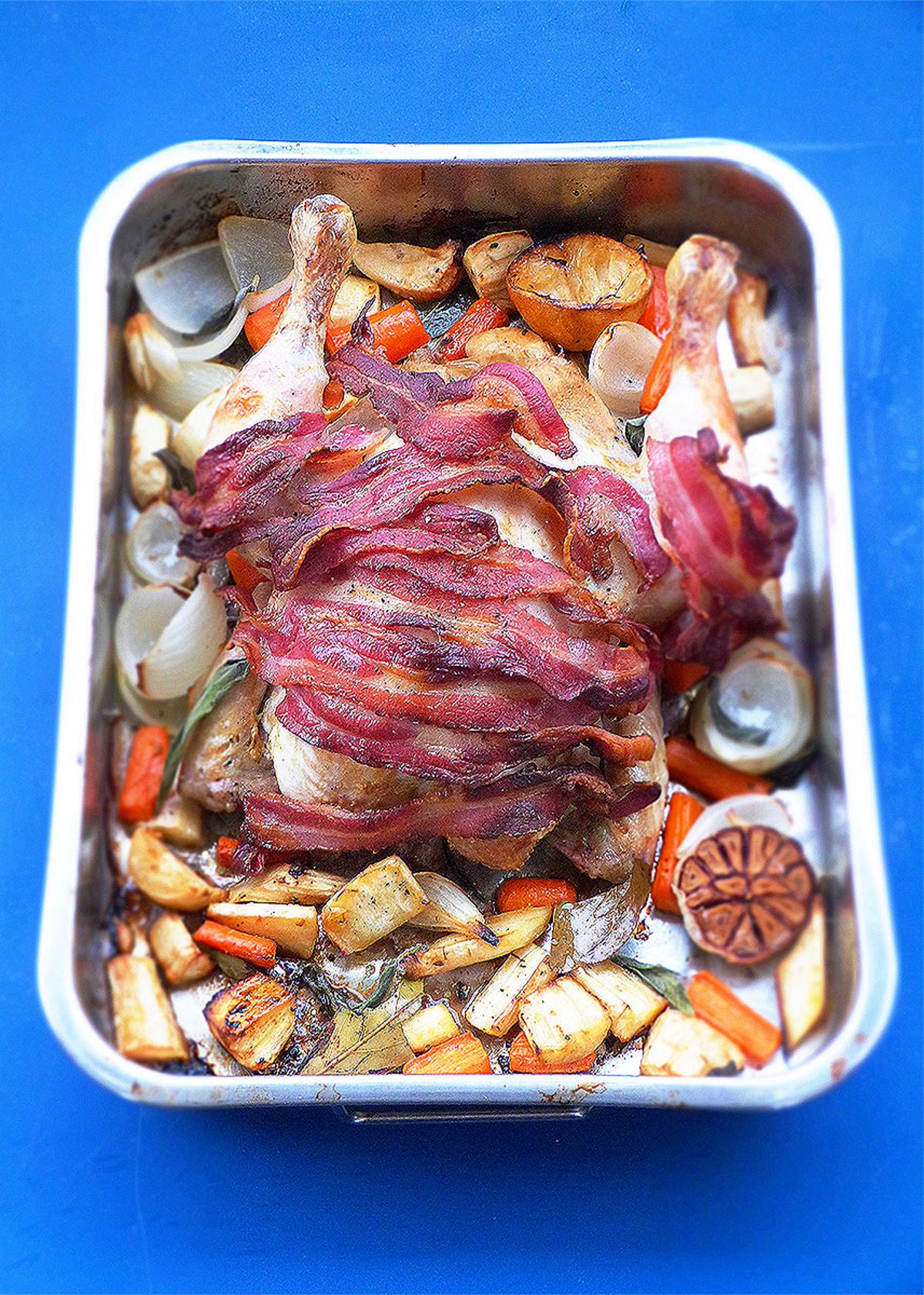 The Christmas Two-Tin Traybake Feast: Roast Chicken with Bacon, Parsnips and Carrots, Roast Potatoes, Pigs in Blankets, Stuffing and Crispy Garlic Sprouts