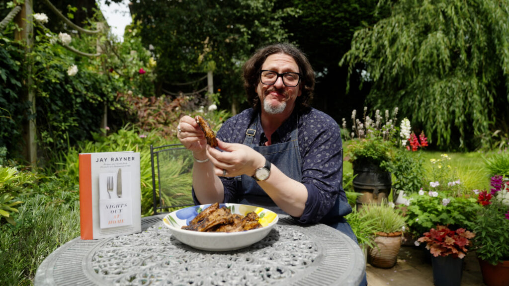 Jay Rayner with a copy of his new cookbook Nights Out At Home