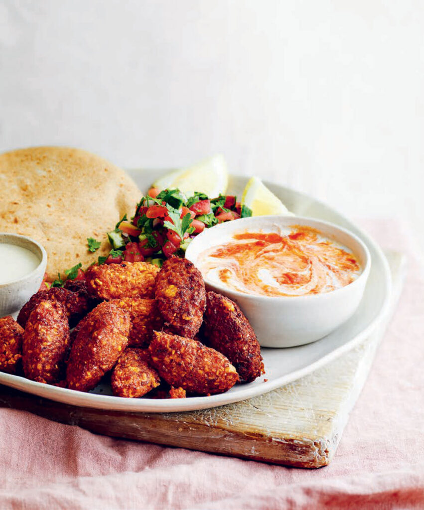 Roasted Tomato Falafels with Tomato Yogurt, Pickles, Chopped Salad and Flat Breads